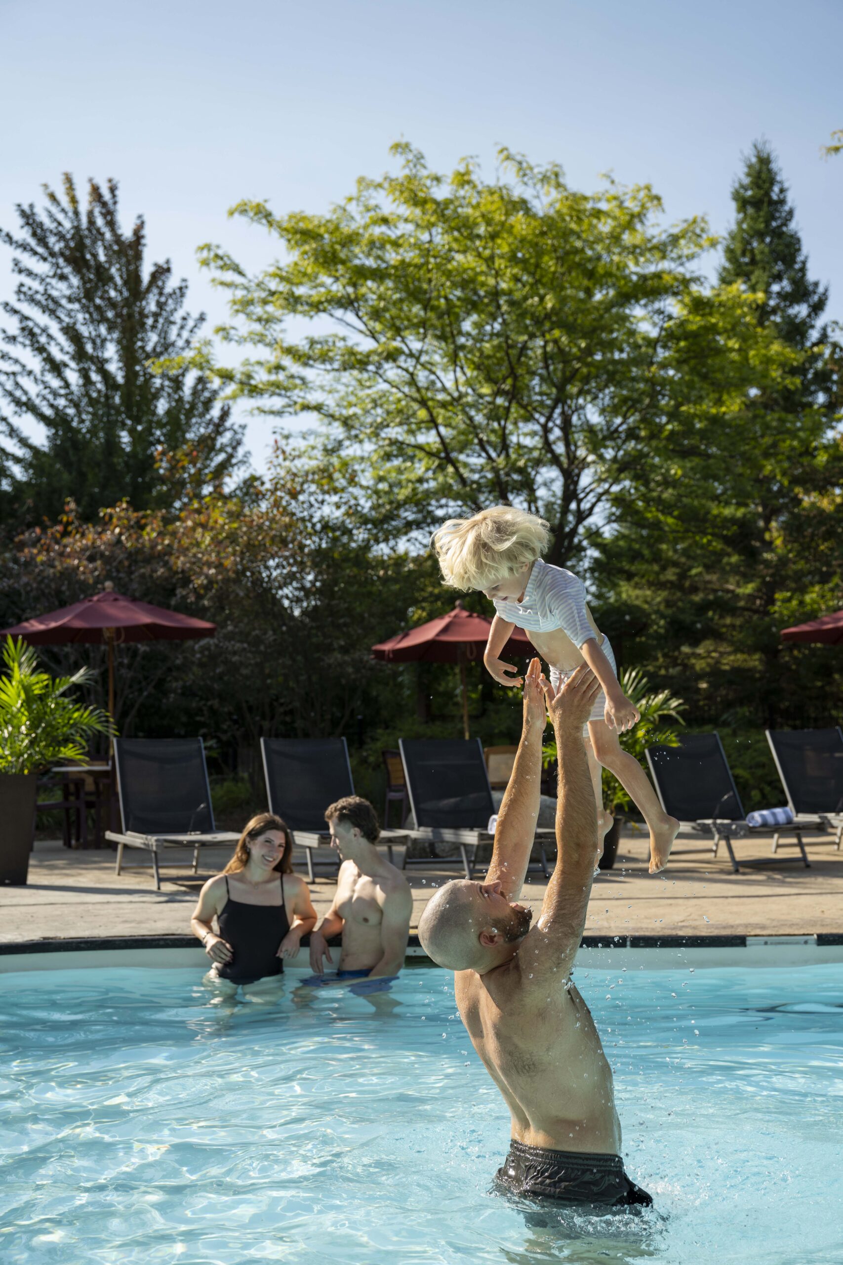 Family enjoying the outdoor pool at Georgian Bay Hotel in Collingwood